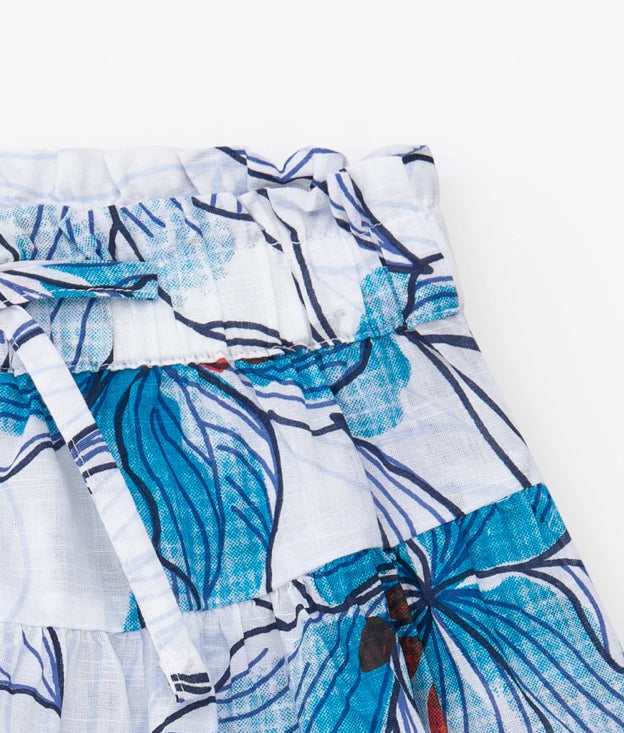 TucTuc NK Beyond The Beach Camiseta niña en azul cobalto con estampado floral lateral Short para niña en blanco con cintura elástica y lazo decorativo